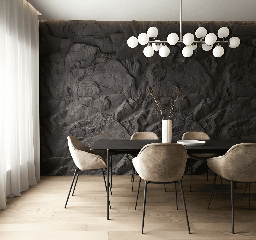Mur en pierre noire dans une salle à manger avec table ronde et suspension